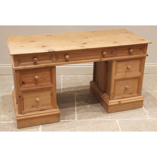 663 - A Victorian style pine twin pedestal desk, late 20th century, the rectangular moulded top over three... 