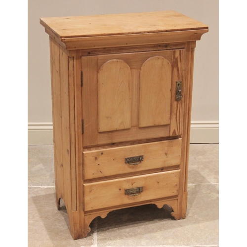 664 - A late Victorian pine side cabinet, the single cupboard door over two drawers, flanked by inset plai... 