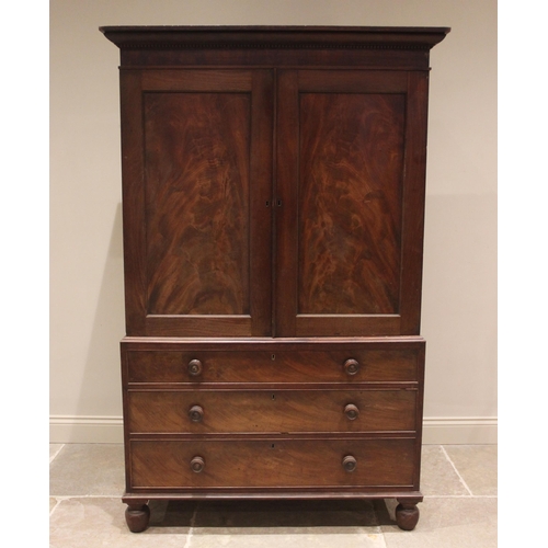 672 - A mahogany linen press, mid 19th century, the cavetto cornice with a beaded frieze above a pair of f... 