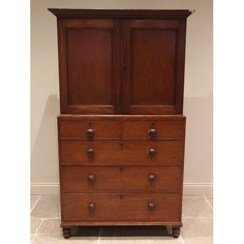 673 - A walnut linen press, 19th century, the cavetto cornice over a pair of panelled doors opening to fou... 