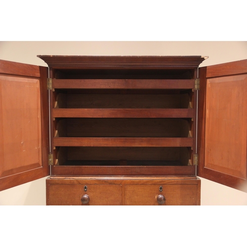 673 - A walnut linen press, 19th century, the cavetto cornice over a pair of panelled doors opening to fou... 