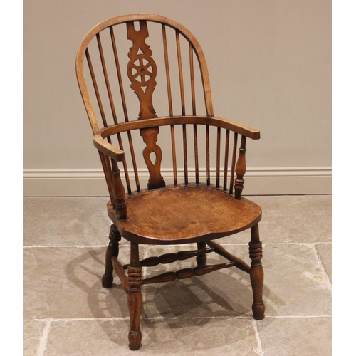 677 - A 19th century style ash and beech wheel back Windsor elbow chair, 20th century, with a hoop back an... 