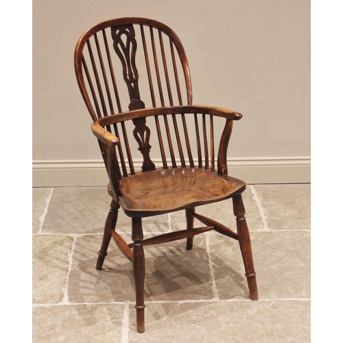 686 - A 19th century yew and elm Windsor elbow chair, the hoop back with central pierced splat above the f... 