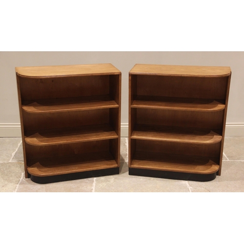 693 - A pair of Art Deco honey oak open bookcases, early 20th century, each of rounded rectangular form wi... 