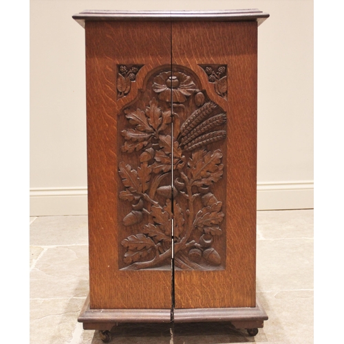 694 - A carved oak side cabinet, late 19th/early 20th century, the rectangular moulded top over a single d... 