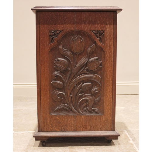 694 - A carved oak side cabinet, late 19th/early 20th century, the rectangular moulded top over a single d... 