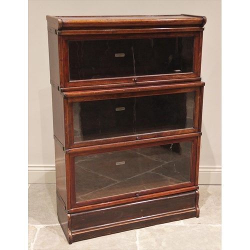 699 - A Globe Wernicke walnut three tier stacking bookcase, early 20th century, each tier with an 'up and ... 