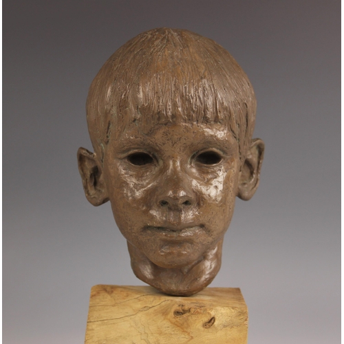 538 - Maureen Coatman (British, 1919–2005), a clay bust of a young boy, signed at base of neck, finished i... 