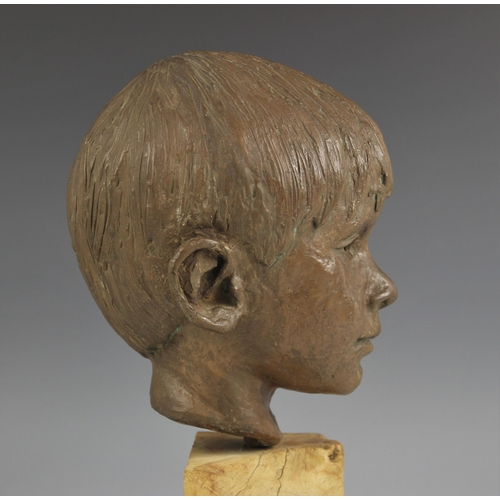 538 - Maureen Coatman (British, 1919–2005), a clay bust of a young boy, signed at base of neck, finished i... 