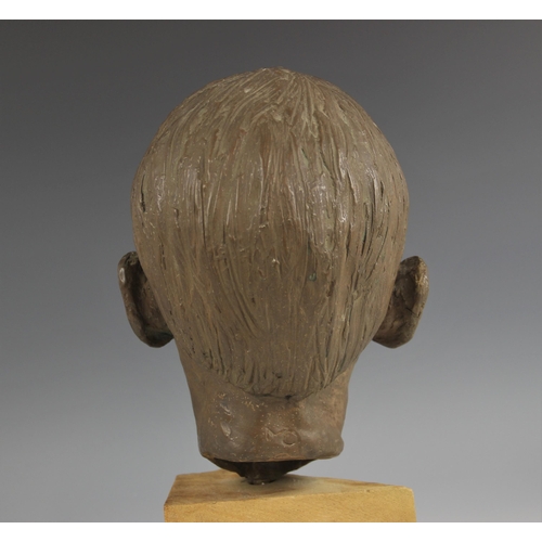 538 - Maureen Coatman (British, 1919–2005), a clay bust of a young boy, signed at base of neck, finished i... 