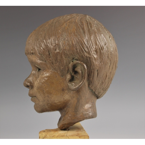 538 - Maureen Coatman (British, 1919–2005), a clay bust of a young boy, signed at base of neck, finished i... 