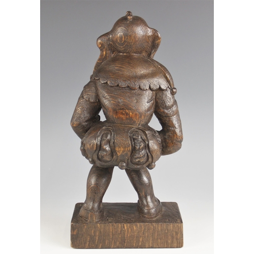 545 - A 17th century style carved oak figure of Rigoletto, 20th century, modelled in jester attire upon an... 