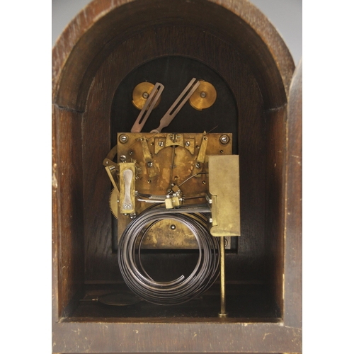 611 - A 1920's oak cased bracket clock retailed by Pleasance & Harper, Bristol, the arched case with barle... 