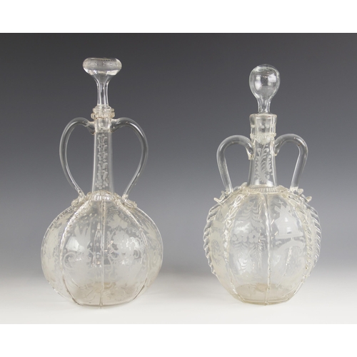 498 - Two Dutch globe and shaft decanters, each with twin handles, the globes sectioned with prunted and t... 