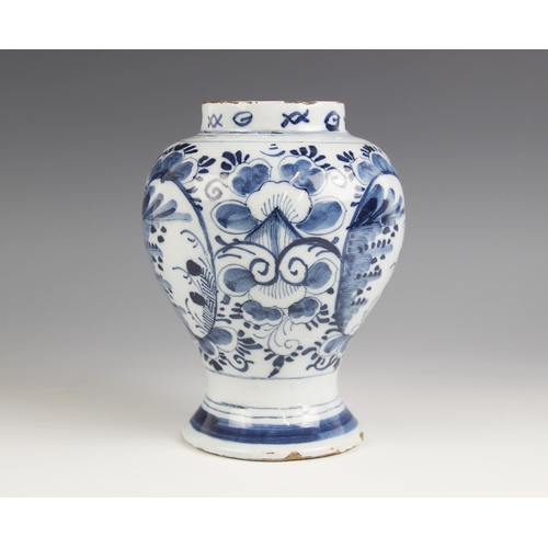 476 - A Delft tin glazed earthenware blue and white vase, of inverted baluster form with raised neck and s... 