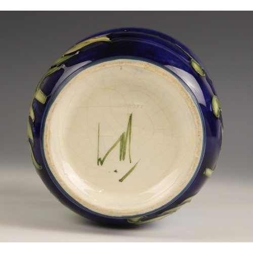 489 - A Moorcroft cache pot in the Hibiscus pattern against a blue ground, mid to late 20th century, impre... 