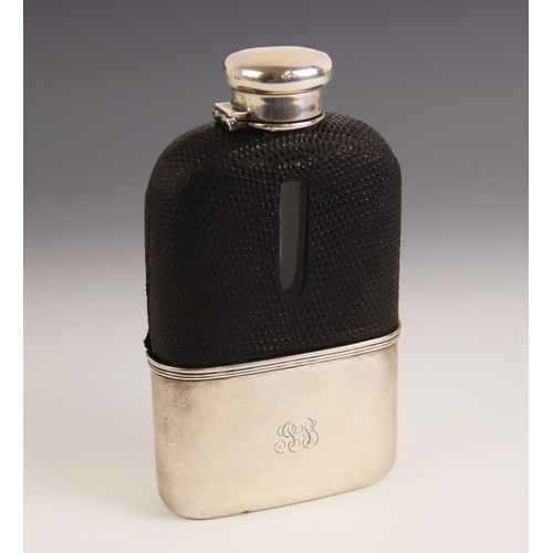 100 - A silver mounted glass hip flask by Tiffany & Co, the colourless glass body with black leather mount... 