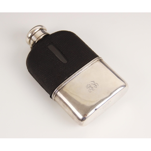 100 - A silver mounted glass hip flask by Tiffany & Co, the colourless glass body with black leather mount... 