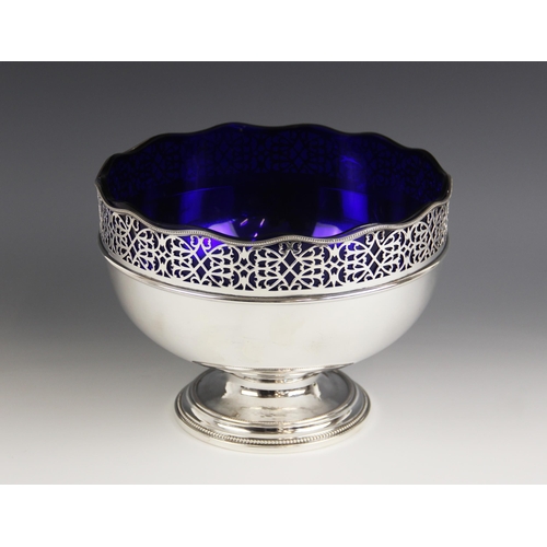 103 - A silver plated fruit bowl, of circular form with pierced scrolling border and waved beaded rim, upo... 