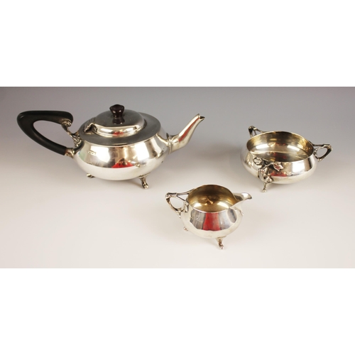 106 - An Arts & Crafts three-piece silver tea service, Charles Edwards, Birmingham 1879, comprising teapot... 