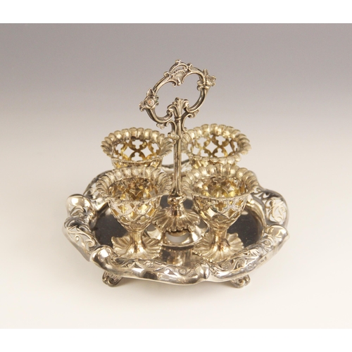 112 - A silver plated egg cruet by Elkington & Co, comprising four egg cups, each with pierced decoration ... 