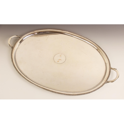 114 - A twin-handled silver plated tray, of oval form with gadroon border and foliate capped handles, vaca... 