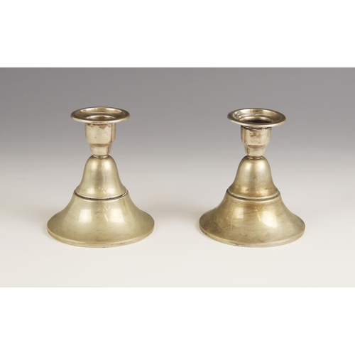 63 - A pair of Dutch silver candlesticks, each sconce upon a stepped bell-shaped weighted base, dated 197... 