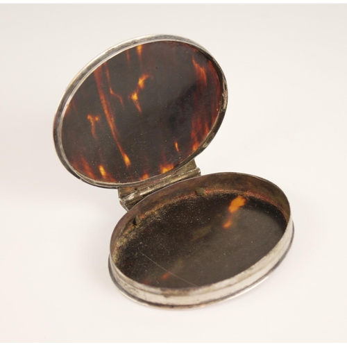 80 - A 19th century silver coloured and tortoiseshell snuff box, of oval form, the tortoiseshell cover in... 