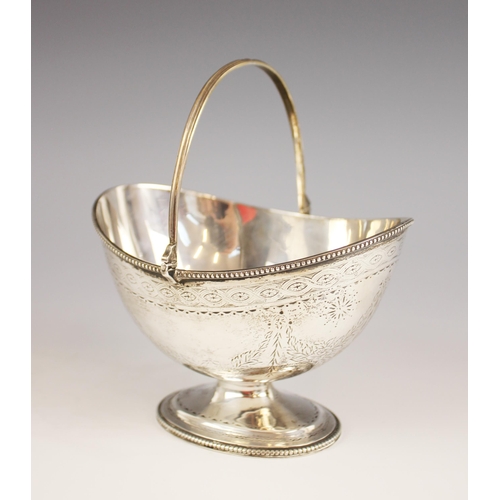 91 - A Victorian silver swing-handled bon-bon dish, London 1868 (makers mark worn), the oval bowl raised ... 