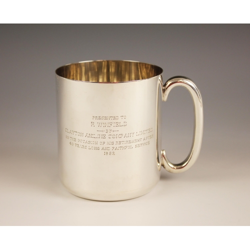 97 - A Victorian silver mug, Thornhill & Co, London 1885, of cylindrical form with C-scroll handle, inscr... 