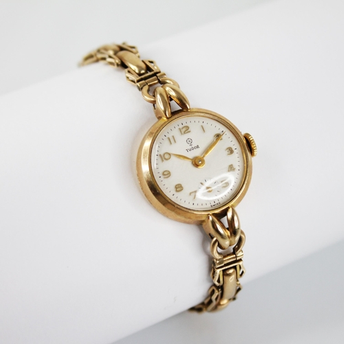 119 - A ladies vintage 9ct gold Tudor wristwatch, the round white dial with Arabic numerals and subsidiary... 