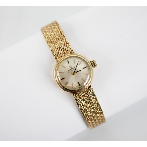 120 - A ladies vintage Omega Automatic 9ct gold wristwatch, the circular dial with baton markers, set to a... 