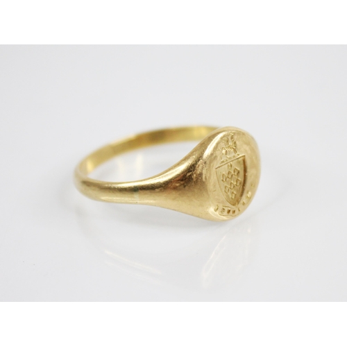 133 - An early 20th century 18ct gold signet ring, the oval shaped head with a crest depicting a griffin u... 