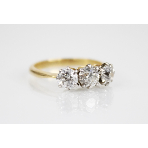 149 - A diamond three stone ring, the central round old cut diamond weighing approximately 0.50 carats (4.... 