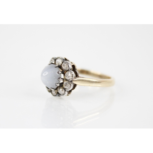 153 - A star sapphire and diamond cluster ring, the central sapphire cabochon measuring 6.4mm x 5.9mm x 4.... 