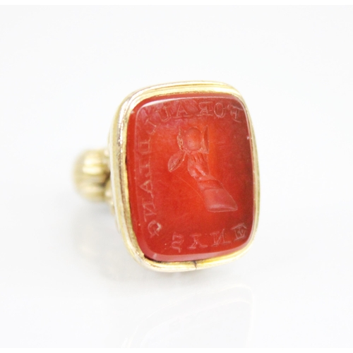 161 - A 19th century carnelian set seal fob, the matrix engraved ‘For Auld Lang Syne’ with arm holding a f... 