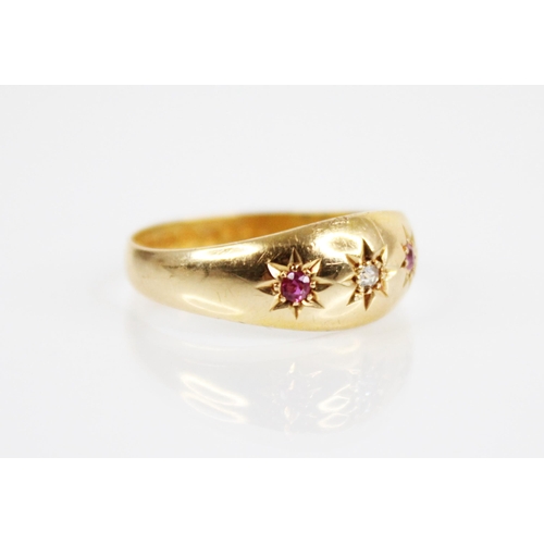 175 - An Edwardian diamond, ruby and 18ct gold ring, comprising a central mixed cut diamond flanked by two... 