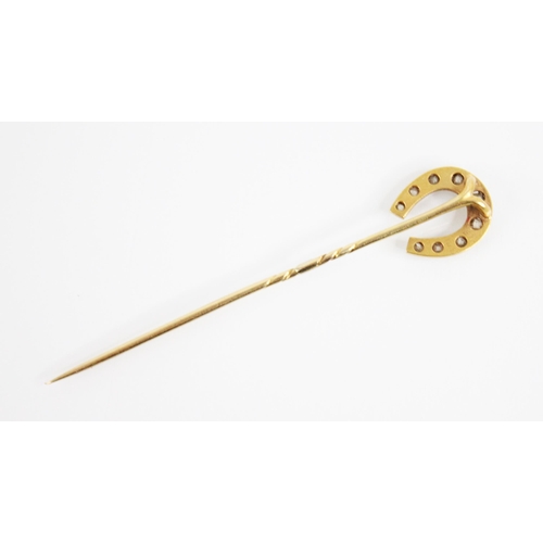 203 - A Victorian diamond set horseshoe stick pin, the head set with nine graduated rose cut diamonds, all... 