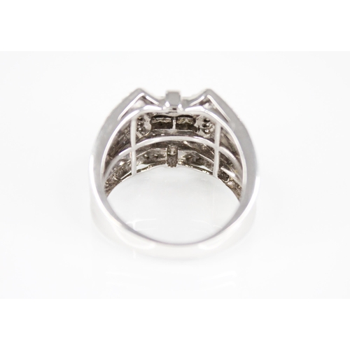 208 - A 14ct white gold diamond set ring, the central rectangular panel set with eight princess cut diamon... 