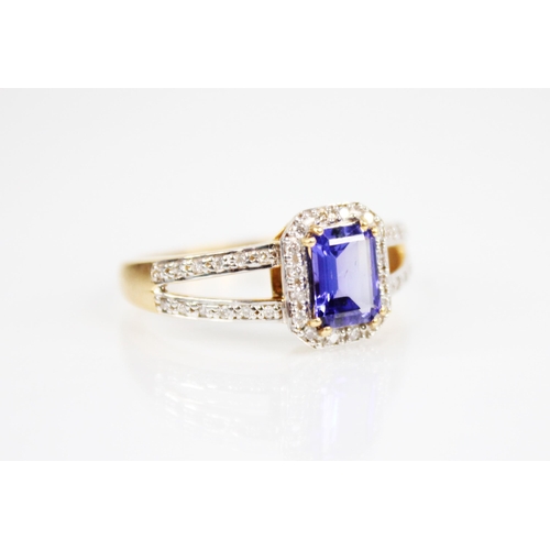 209 - A tanzanite and diamond 18ct gold ring, the central emerald cut tanzanite measuring 8mm x 6mm, withi... 