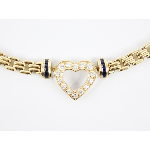 221 - An 18ct gold diamond and sapphire necklace, the pierced heart shaped pendant set with brilliant cut ... 