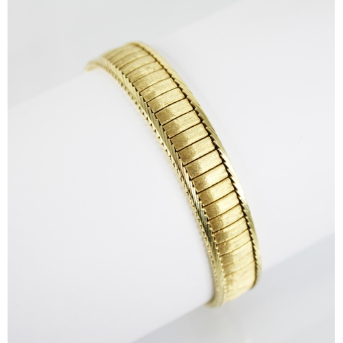 222 - An 18ct gold continental bracelet, the rectangular link bracelet with textured finish, herringbone b... 