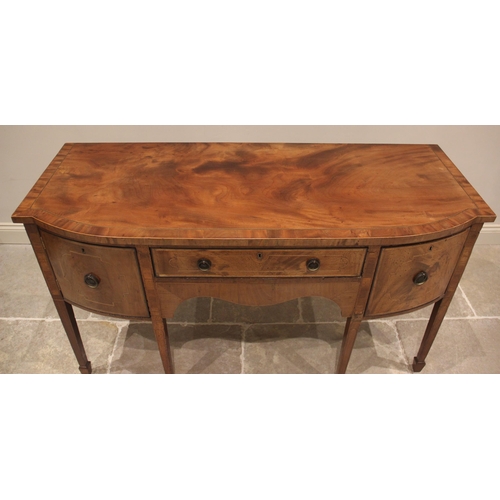 628 - A George III mahogany bow front sideboard, outlined with ebony and boxwood stringing, the shaped and... 