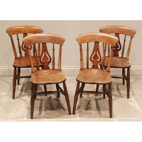 691 - A set of four Victorian elm and beech kitchen chairs, each with a pierced and inverted vase shaped s... 