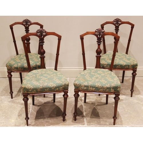 691 - A set of four Victorian elm and beech kitchen chairs, each with a pierced and inverted vase shaped s... 