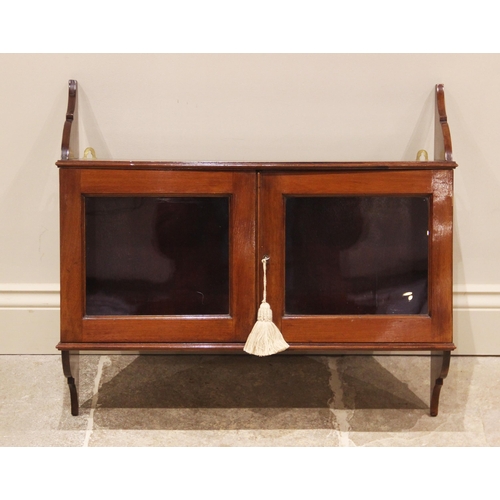 695 - A glazed mahogany hanging wall cabinet, early 20th century, the curved brackets united by a pair of ... 