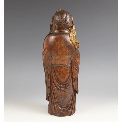 400 - A Chinese carved bamboo figure of Zhongli Quan, gilt highlighted, modelled standing holding a fan, 3... 