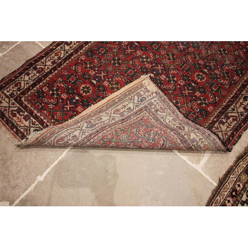 578 - A Caucasian hand knotted wool carpet, in brown, blue, black and white colourways, the central field ... 