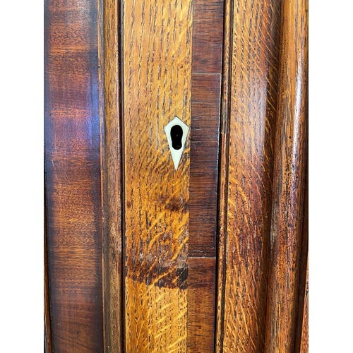 644 - A George III oak, mahogany and rosewood crossbanded housekeepers cupboard, the upper section of brea... 