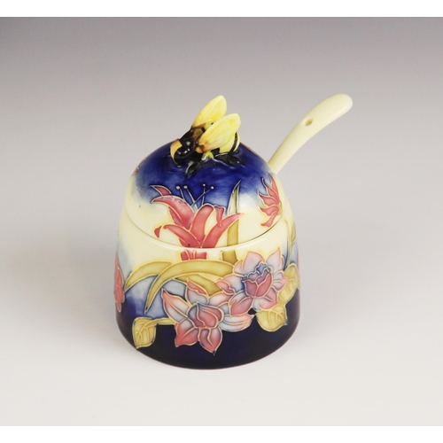 139 - An Old Tupton ware honey pot, cover and spoon, tube lined and hand painted with a continuous floral ... 